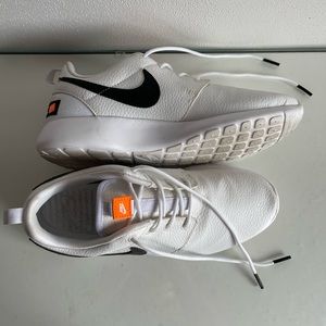 White faux leather Nike tennis shoes/sneaker with orange accents. Size 7